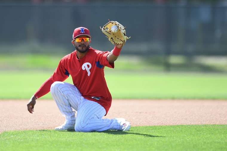 Jesmuel Valentin fields a ball during spring training workouts.