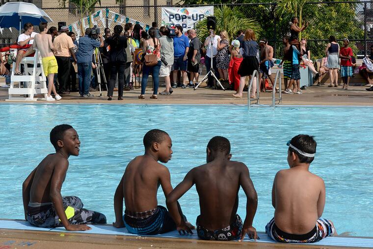 Youngsters wait for the officials’ “Pop-Up Pool” speeches to end so they can get back into the water. (TOM GRALISH / Staff Photographer)