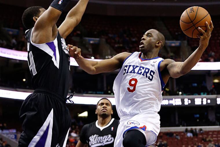 James Anderson, right, goes up to shoot against Sacramento Kings's Jason Thompson during the second half of an NBA basketball game on Wednesday, March 12, 2014, in Philadelphia. (Matt Slocum/AP)
