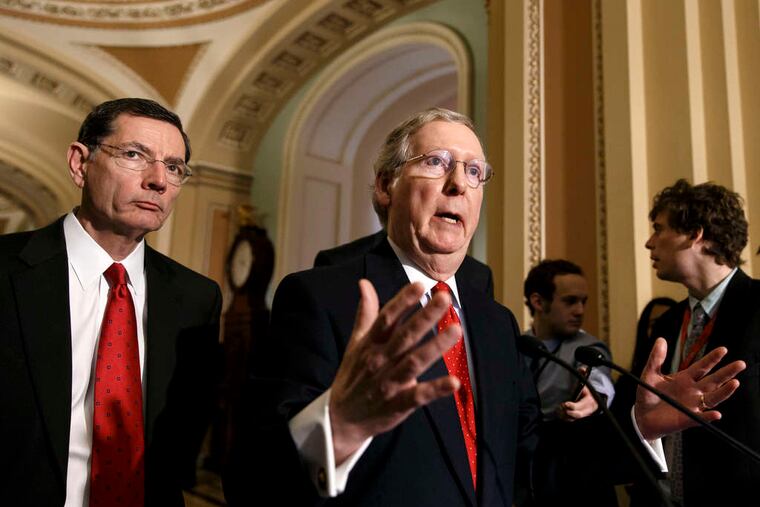 Minority Leader Mitch McConnell (R., Ky.), with Sen. John Barrasso (R., Wyo.), speaks to reporters after the Senate's rejection of Debo Adegbile.