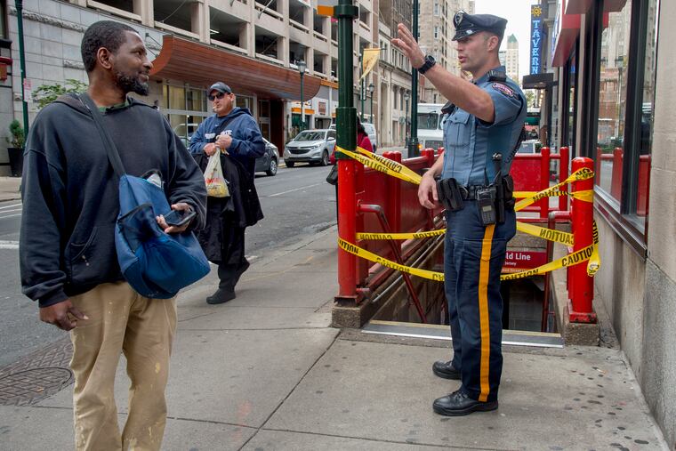 Delaware River Port Authority Police patrolman D. Batdorf gives directions to commuters (no IDS) as the the PATCO station at 15th-16th & Locust was closed October 16, 2018 after a power failure knocked out service at every station in Philadelphia except for the one at 8th and Market Streets.