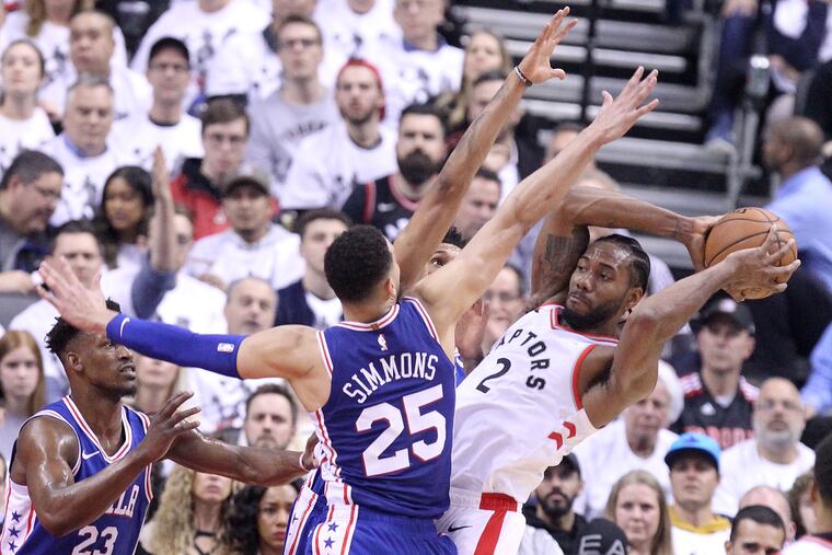 Ben Simmons and Jimmy Butler converge on the Raptors' Kawhi Leonard in Game 2.
