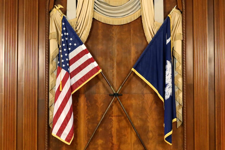 The U.S. and South Carolina flags hang in the South Carolina statehouse, March 16, 2021, in Columbia, S.C . The Democratic National Committee chose South Carolina to hold the first primary for the 2028 presidential race.