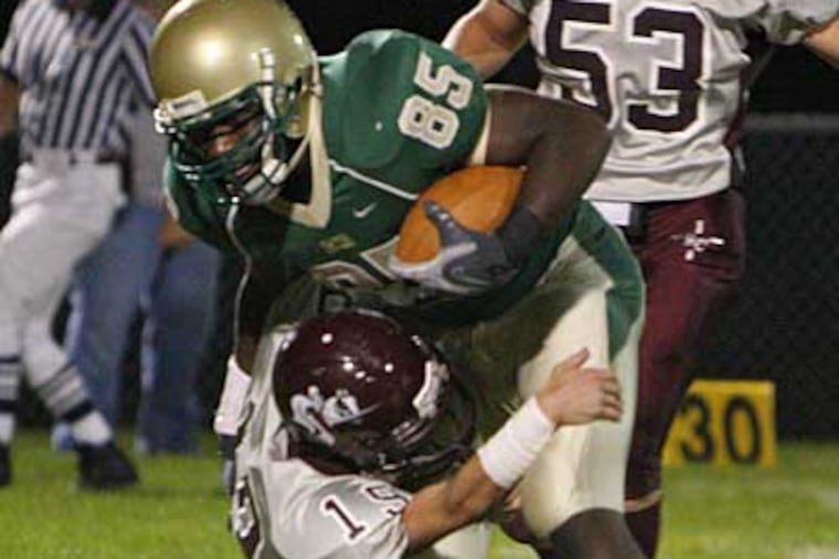 Camden Catholic's Sherard Cadogan is tackled by Holy Cross' Austin Stein. (Kevin Cook/ File photo)