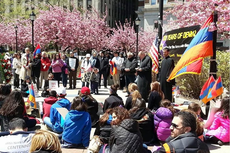 Protesters stage a 100-minute silent sit-in at LOVE Park on Friday to mark 100 years since the genocide of Armenians at the hands of the Ottoman Empire during World War I.