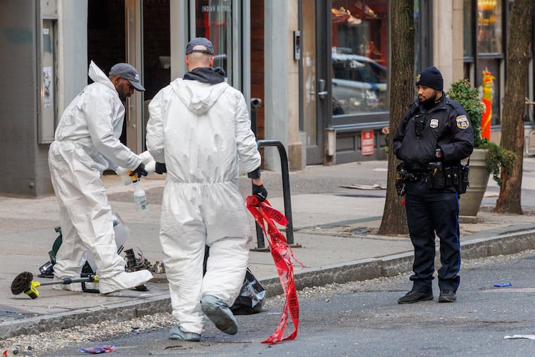 Crime scene cleaning team taking care of scene along Chestnut Street in Center City, Wednesday morning April 16, 2025. This is where a light pole was taken down after shooting around corner on 18th St.