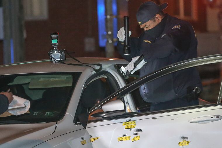 Police investigate a double shooting in the 1200 block of South 51st Street. The white car has at least 10 bullet holes in it. Police said two males, one age 21 and one approx. 16 were shot multiple times. Crime scene unit recover a handgun with an extended magazine from the car. Monday, December 28, 2020.