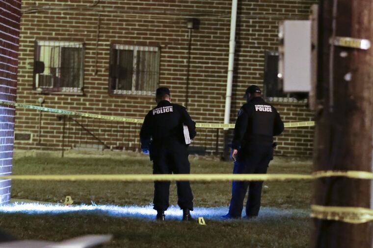 Camden County Police investigate the area where a police officer was shot in the leg by a suspect Wednesday night.