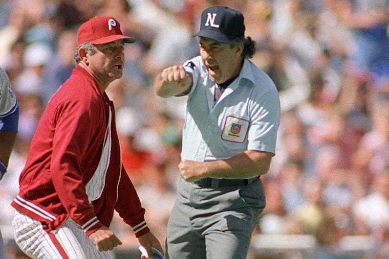 Umpire Frank Pulli, right, ejects Philadelphia Phillies manager Lee Elia during the seventh inning against the Los Angeles Dodgers at Veterans Stadium in Philadelphia, Aug. 23, 1987. Elia argued that Dodgers base runner Tito Landrum should not have been allowed to advance to third after a fan interfered with the ball in play. (AP Photo/Charles Krupa)