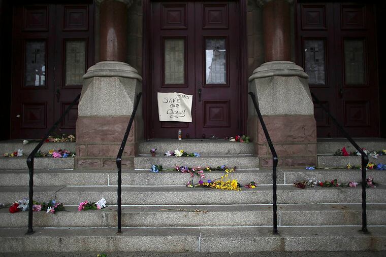 Flowers lay on the steps of St. Laurentius in Fishtown on April 23, 2015. (Joseph Kaczmarek/For the Daily News)