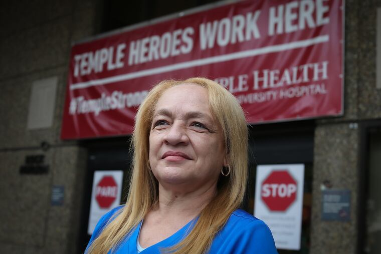 Maria Rodriguez, an oncology nurse at Temple University Hospital, poses for a portrait outside the hospital.