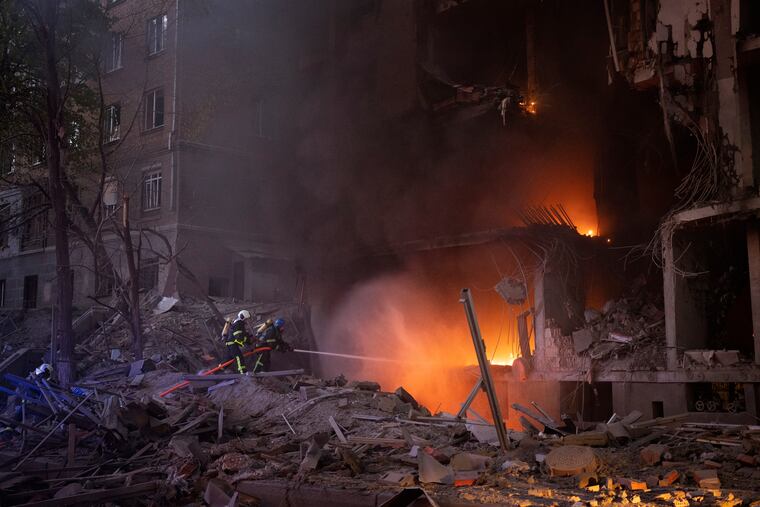 Firefighters try to put out a fire following an explosion in Kyiv on Thursday.