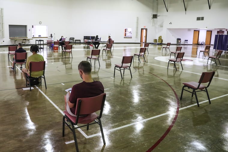 People sit in the waiting area after receiving their monkeypox vaccine at the Dr. Ala Stanford Center for Health Equity in North Philadelphia.