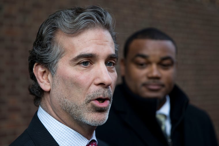In this Nov. 19, 2014, file photo, co-lead players' lawyer Christopher Seeger, left, and former NFL player Shawn Wooden speak with members of the media after a hearing on the proposed NFL concussion settlement outside of the U.S. Courthouse in Philadelphia.