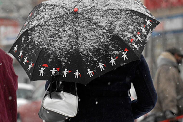 An umbrella comes in handy for this woman in Germantown. (Ron Tarver
/ Staff Photographer)