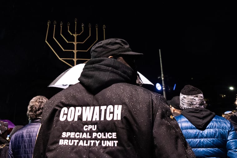 A member of Cop Watch joins New Yorkers in solidarity at the lighting of the Menorah on the 8th night of Chanukah at Grand Army Plaza in Brooklyn, New York, on December 29, 2019.