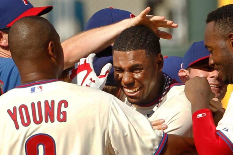 John Mayberry Jr. is swarmed by teammates after driving in the winning run to give the Phillies a 4-3 win over the Chicago White Sox. (Ron Cortes/Staff Photographer)