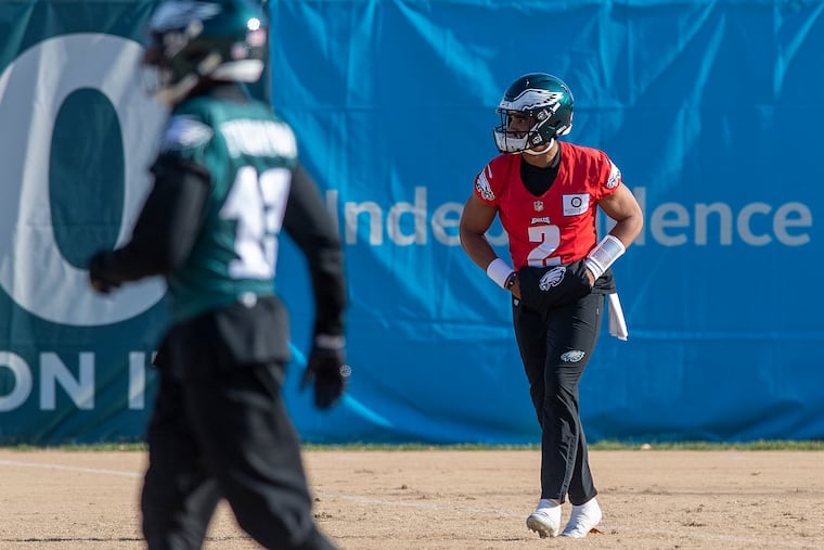 Eagles quarterback Jalen Hurts looks on during practice Friday at the NovaCare Complex.