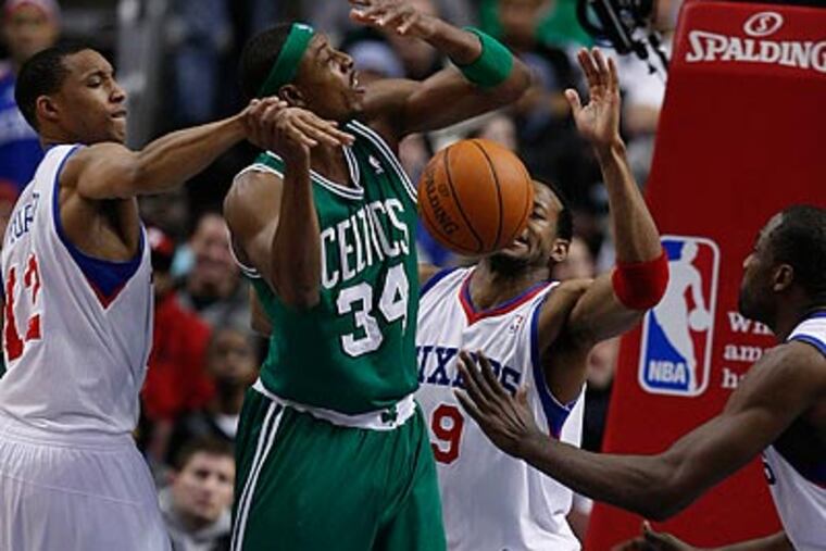 Evan Turner knocks the ball out of the hands of Paul Pierce as Andre Iguodala and Elton Brand defend. (Ron Cortes/Staff Photographer)