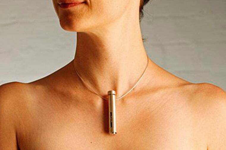 A necklace-ring combo for applying insulin patches for diabetics by designer Leah Heiss is pictured on a model in Melbourne. (AP Photo/David Callow)