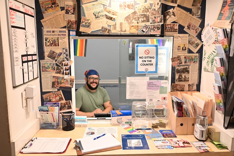 Office manager Samuel Richman greets guests at the reception desk of the Attic Youth Center in Rittenhouse Square East, which serves about 400 young people aged 14 to 23.