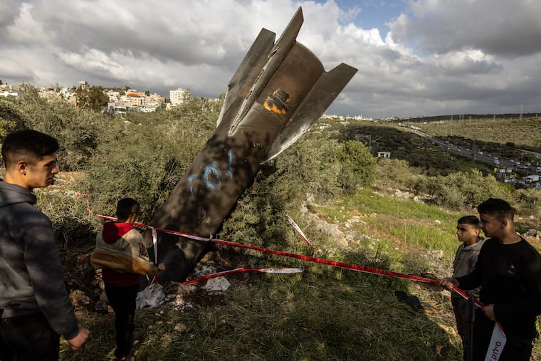 Palestinians in the Israeli-occupied West Bank inspect the remnants of a missile fired from Iran in late March.