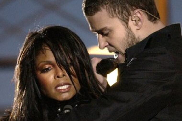 Justin Timberlake reaches across Janet Jackson just before the "wardrobe malfunction" during halftime at Super Bowl XXXVIII.