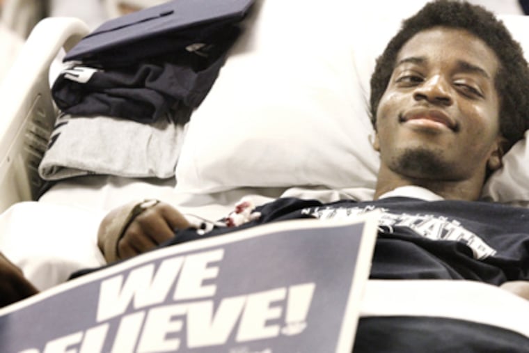 Foday Gibateh, at Magee Rehab, smiles during the graduation, which he saw via Skype. (Elizabeth Robertson / Staff Photographer)