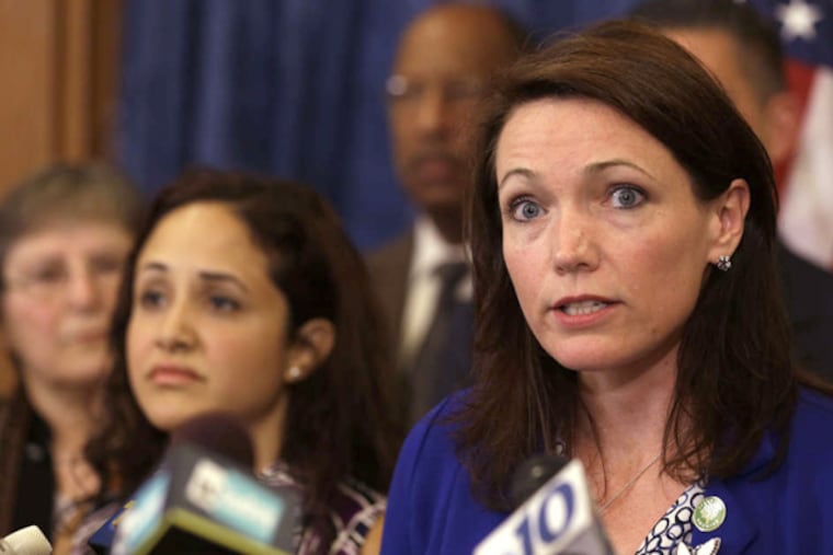 Nicole Hockley, mother of 6-year-old Dylan, who was killed during the Sandy Hook shootings , speaks to reporters. Families from Newtown, Conn., joined other gun control advocates to call for stricter laws. JULIO CORTEZ / AP