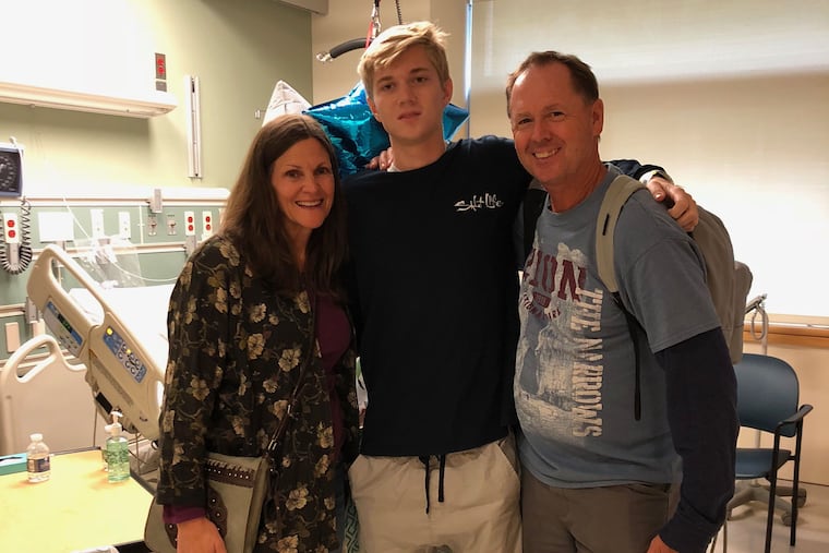 Zachary Reigel, center, with his parents Nancy and Doug Reigel.