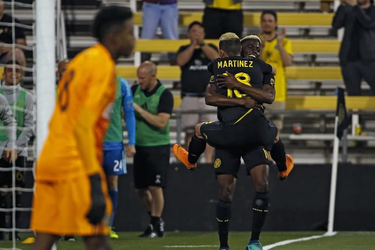 Columbus Crew forward Gyasi Zardes celebrates his goal against the Philadelphia Union with teammate Cristian Martinez.