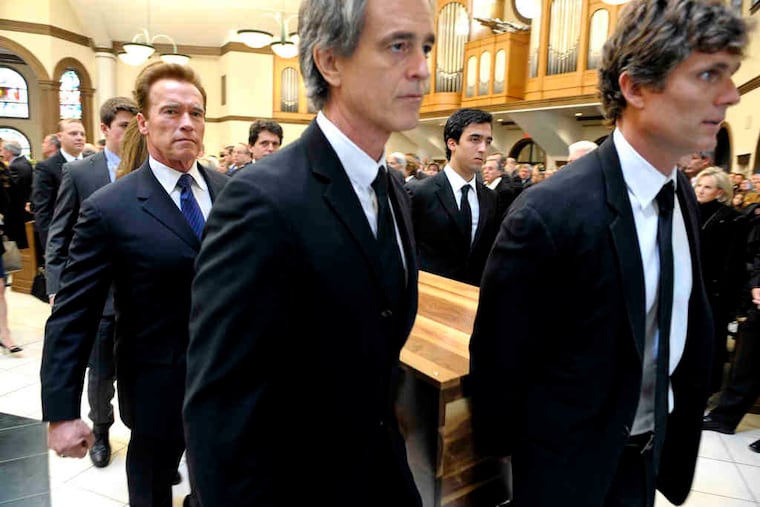 Former California Gov. Arnold Schwarzenegger (left), Bobby Shriver (center), and Anthony Shriver bear Sargent Shriver's casket at Our Lady of Mercy Catholic Church in Potomac, Md.