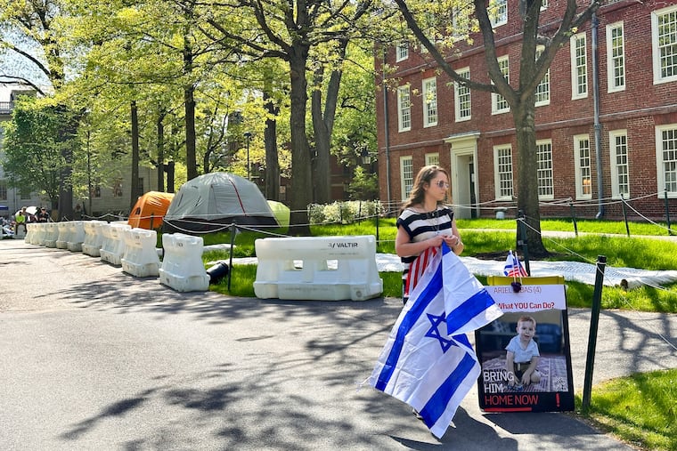 Rotem Spiegler, an alumni of Harvard University, stands near an encampment set up at the university to protest the war in Gaza on Tuesday in Cambridge, Mass. The encampment was being voluntarily removed early Tuesday.