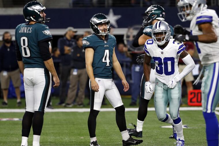 Eagles kicker Jake Elliott (4) and Donnie Jones (left) watch after a missed field goal.