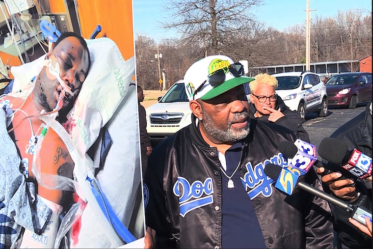 Rodney Wells, right, the stepfather of Tyre Nichols, holds a photo of Nichols in the hospital after his arrest during a Jan. 14 demonstration in Memphis.