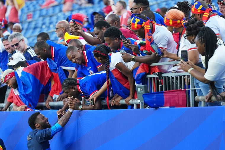 Haiti's Josue Casimir reacts with fans ahead of the World Cup Group C soccer match between Haiti and Scotland in Foxborough, Mass., near Boston, on June 13.