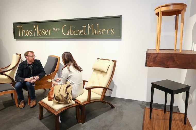 Eric Heidel and Sary Em relax during the opening of the Maine-based high-end furniture maker Thos. Moser at its new 1605 Walnut Street Showroom, Thursday, November 10, 2016.