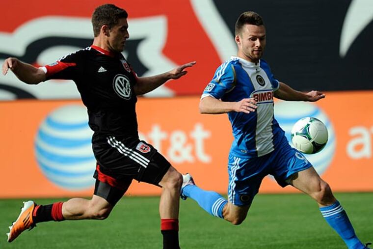 Union forward Jack McInerney chases after the ball against D.C. United defender Chris Korb during the first half. (Nick Wass/AP)