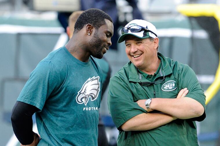 Michael Vick (left) could be reunited with former Eagles offensive coordinator Marty Mornhinweg (right) if he joins the New York Jets.