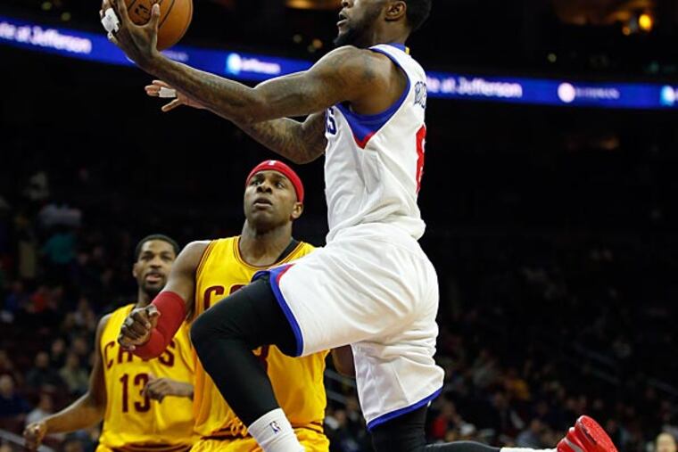 Tony Wroten drives to the basket against the Cavaliers' Brendan Haywood. (Yong Kim/Staff Photographer)