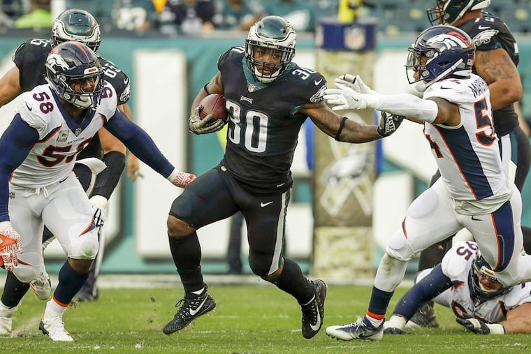 Eagles running back Corey Clement runs past Broncos inside linebacker Brandon Marshall (right) and outside linebacker Von Miller during the third-quarter.