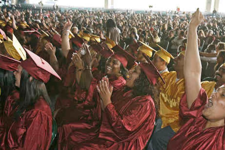 Frances Rivas, 40, of Camden, cheering during Monday's ceremony with her fellow graduates from the Community Education Resource Network.