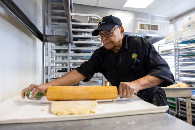George Wright rolls out some pastry dough for making lemon bars, nut bars, and raspberry bars.