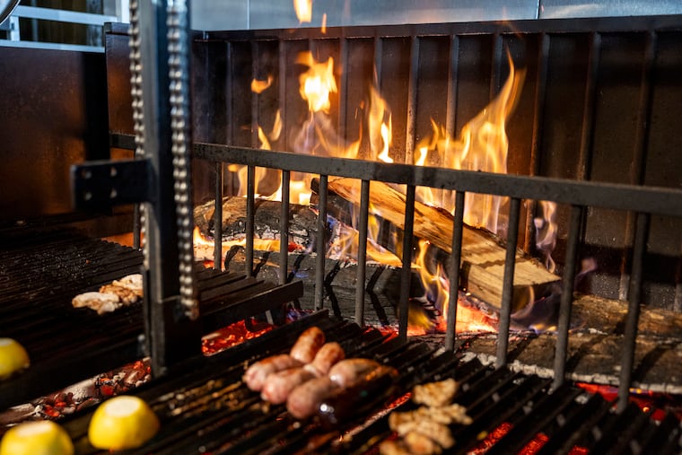 The fire wood grill cooking various meats at La Portena in Stone Harbor, N.J., on Thursday, June 12, 2025.