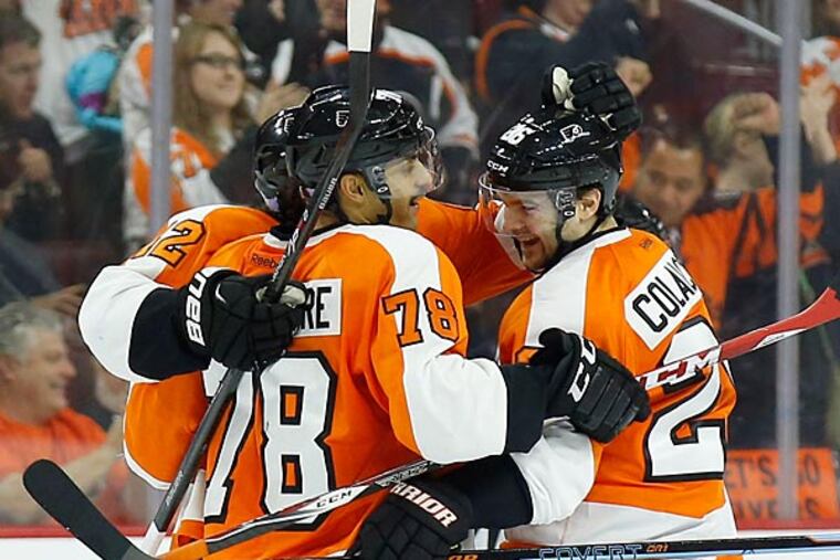 Pierre-Edouard Bellemare celebrates his a goal with teammates Carlo Colaiacovo (right) and Jason Akeson. (Yong Kim/Staff Photographer)