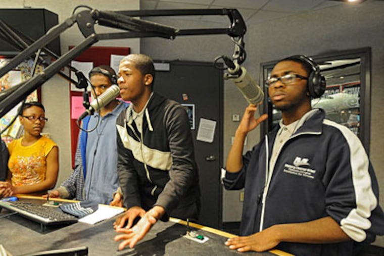 Marques Carson (center), 17, a senior at Mastery Charter School, Thomas Campus (right), talk live on Power 99's the Hot Boyz show (hosted by Uncle O and Mikey Dredd) about flash mobs as fellow teens Martisha Hardy, 17, a senior at Academy at Palumbo, John Laderer, 16, a junior at Overbrook High, and Nicholas Richardson, 17, a senior at Mastery Charter School, listen. (Clem Murray / Staff Photographer)