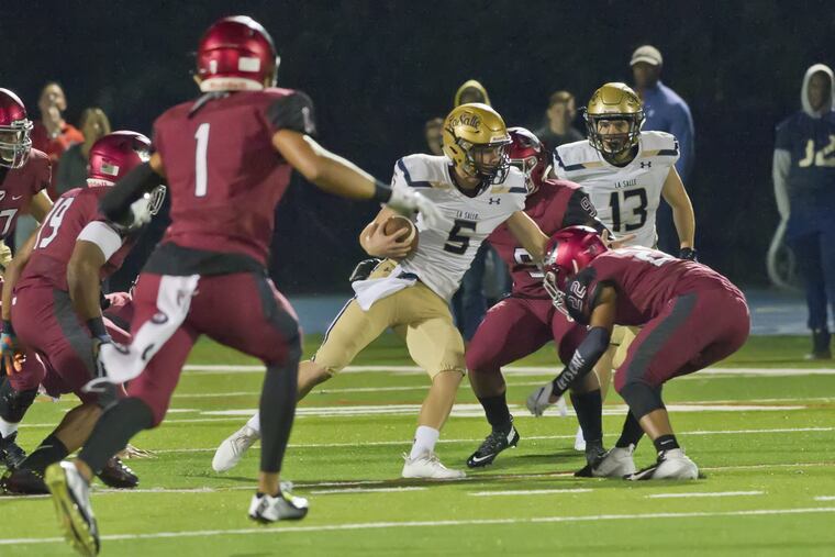 La Salle OB Sean Daly (5) runs the ball in the Explorers' 49-12 loss to St. Joseph's Prep on Sept. 28 at Widener.