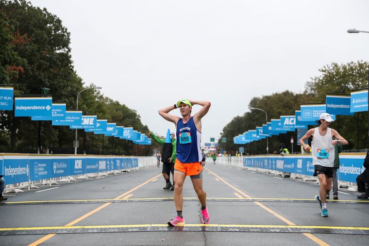 Racers in the Broad Street Run are timed with a radio-frequency I.D. system. Transmitters are hidden beneath mats like these ones, at the finish line of the 10-mile race in 2021.