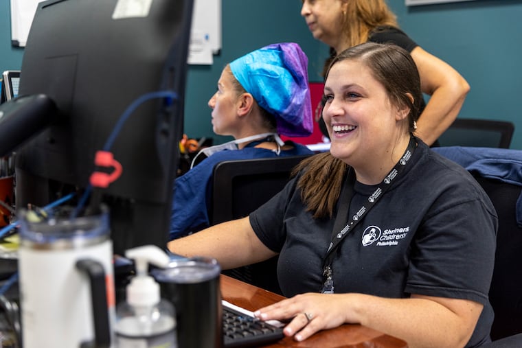 Michelle Murphy, 31, of Northeast Philadelphia, Pa., Radiology Technologist at Shriners Hospital, looking over the x-rays she took of her patient in Philadelphia, Pa., on Tuesday, Aug., 8, 2023.