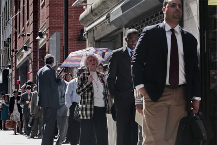 Job seekers wait in line at a job fair in New York City in June. More than 1 million Americans are bracing for a harrowing, post-Christmas jolt as extended federal unemployment benefits come to a sudden halt this weekend, with potentially significant implications for the recovering U.S. economy.